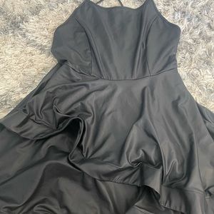 Black leather dress with ruffled bottom.